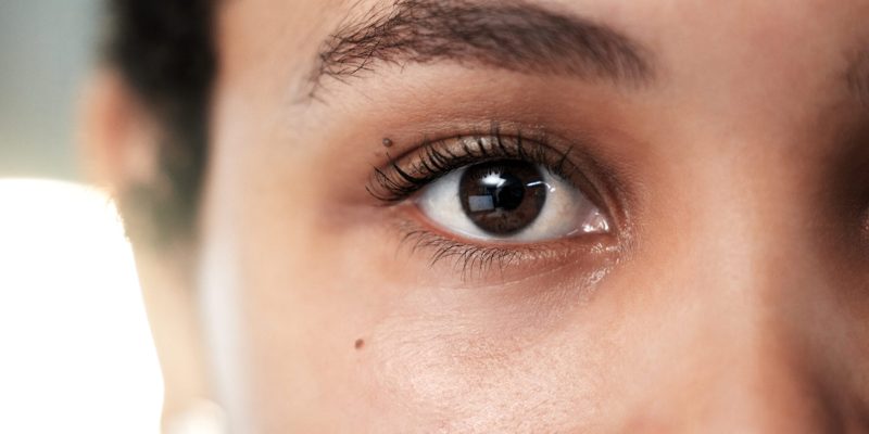 Eyes, vision and eye care with woman and face closeup, contact lens with lashes and eyebrow, focus .